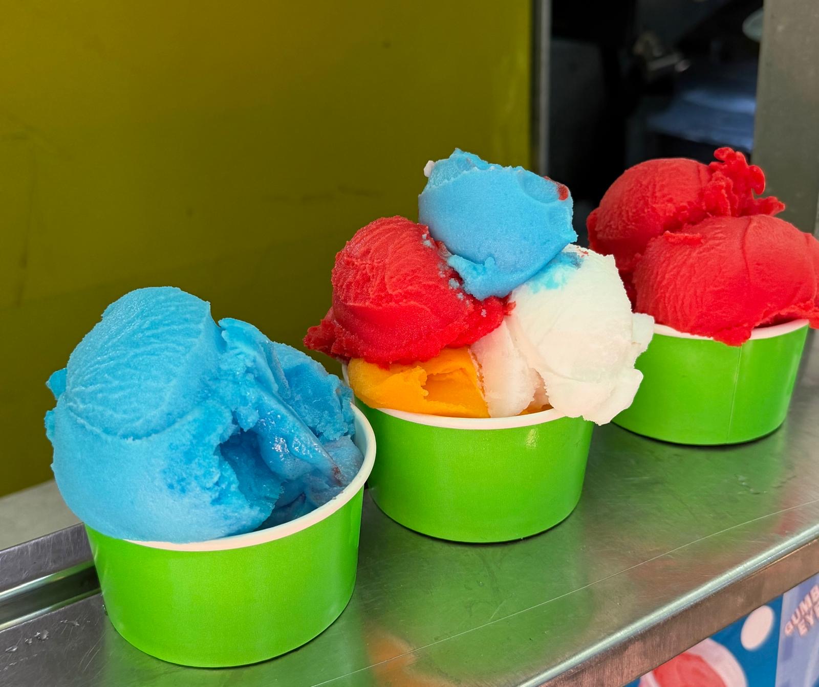 Italian ice cups in blue raspberry, cherry, mango, lemon and rainbow